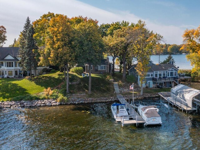 view of dock featuring a water view and a lawn