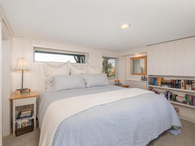 bedroom featuring multiple windows and carpet