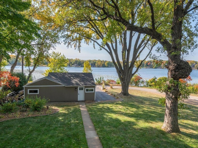 view of yard with an outbuilding and a water view