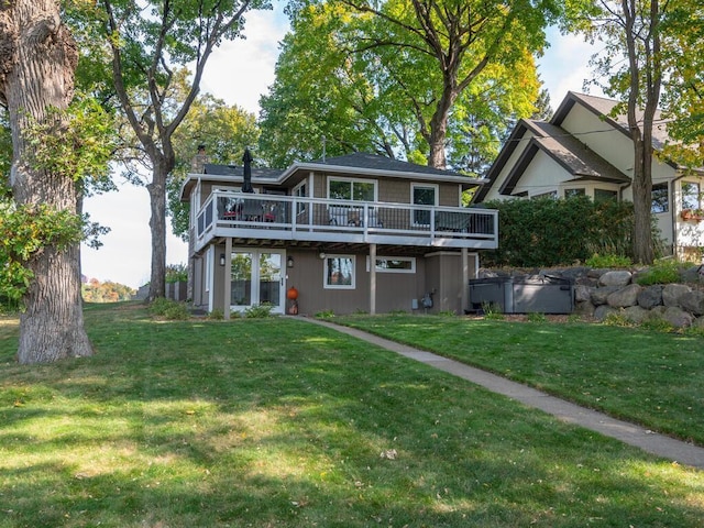 back of property featuring a yard, a chimney, and a wooden deck