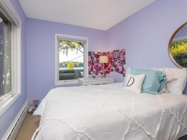 bedroom featuring a baseboard radiator and carpet