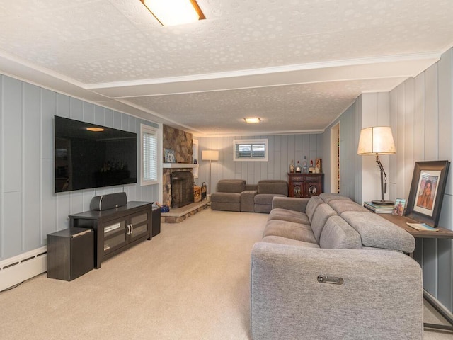 carpeted living room featuring baseboard heating, a fireplace, a textured ceiling, and crown molding