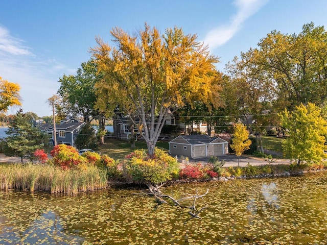 view of yard with an outdoor structure and a water view