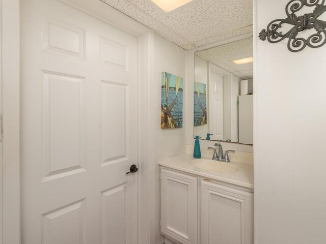 bathroom with vanity and a paneled ceiling