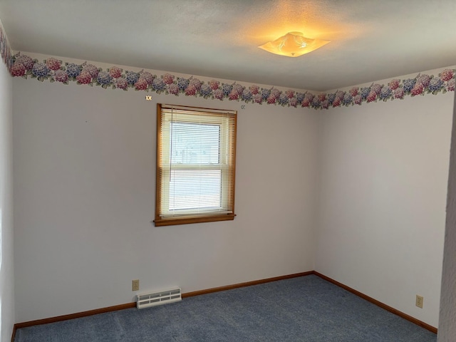 carpeted empty room with baseboards and visible vents