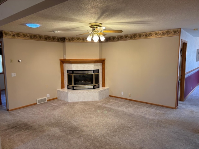 unfurnished living room featuring visible vents, carpet flooring, a fireplace, a textured ceiling, and a ceiling fan