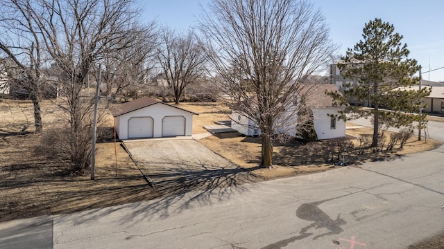 exterior space featuring a detached garage and an outbuilding