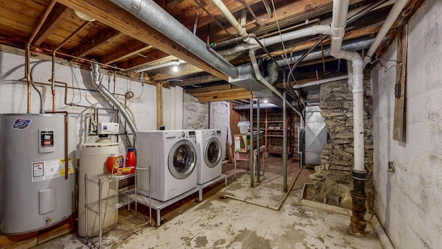 unfinished basement with heating unit, electric water heater, and independent washer and dryer