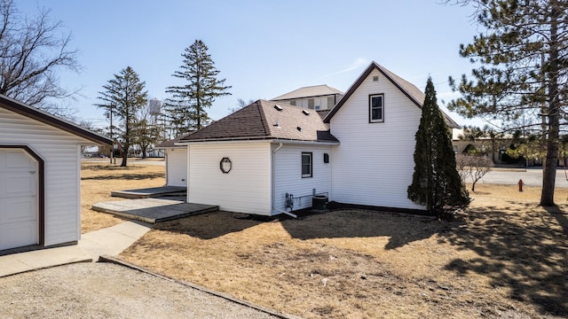 view of property exterior featuring roof with shingles