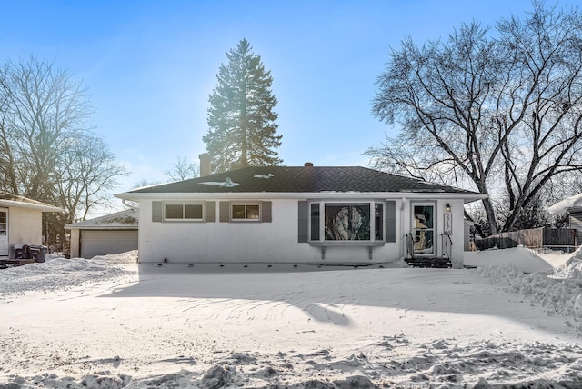 single story home with an outbuilding, fence, and a detached garage