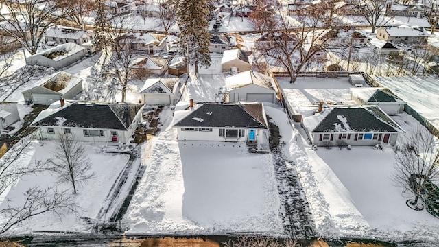 snowy aerial view with a residential view