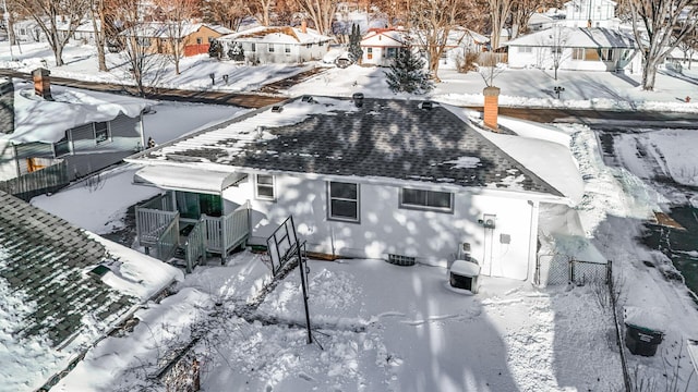 snowy aerial view featuring a residential view