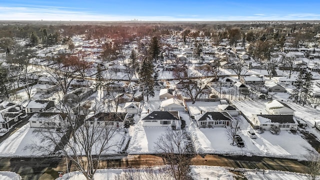 snowy aerial view featuring a residential view