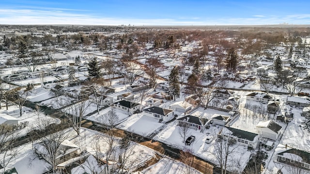 snowy aerial view featuring a residential view