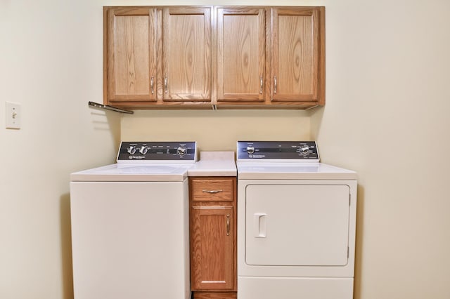 laundry room featuring cabinet space and washing machine and dryer