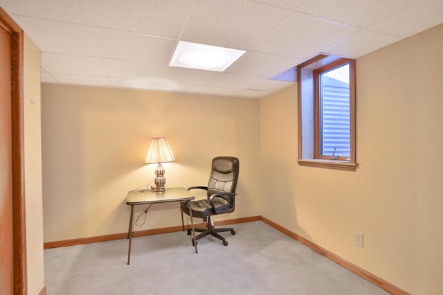 office area featuring a drop ceiling, baseboards, and carpet