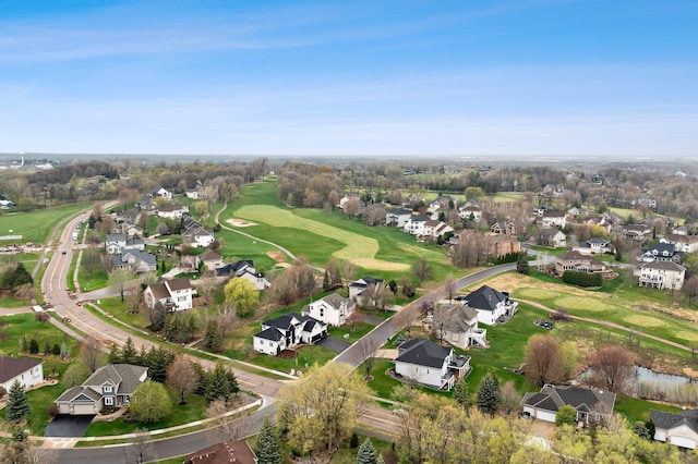 birds eye view of property featuring view of golf course and a residential view
