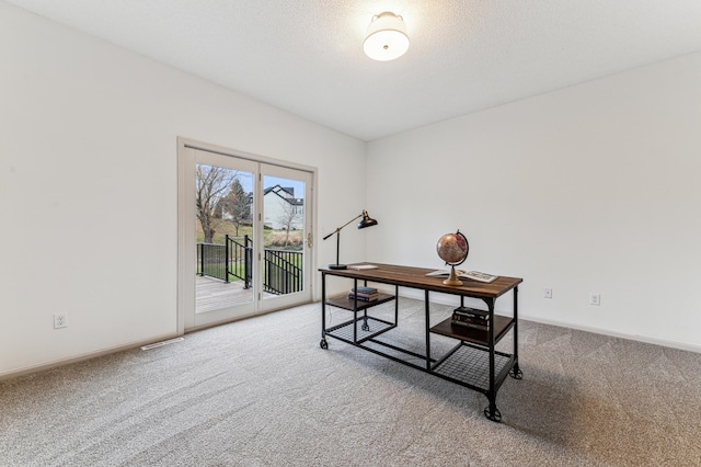 carpeted home office with baseboards and visible vents