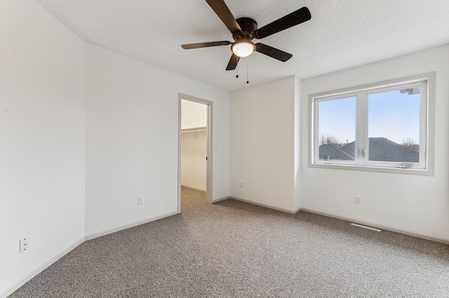 unfurnished room featuring baseboards, carpet flooring, and ceiling fan