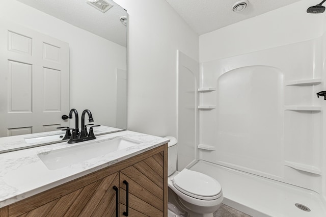 full bathroom with a textured ceiling, visible vents, a shower, vanity, and toilet