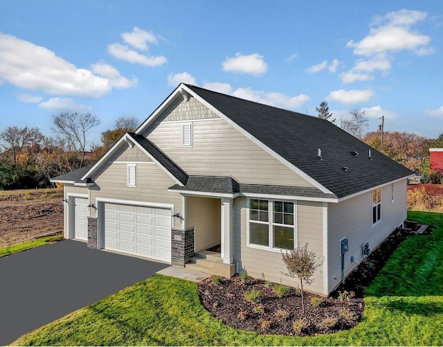 view of front facade featuring driveway, a front lawn, an attached garage, and a shingled roof