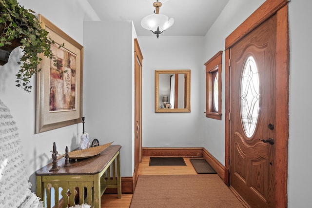 foyer entrance featuring baseboards