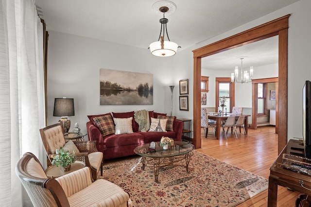 living area featuring wood-type flooring and a notable chandelier