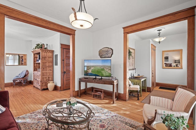 living area with baseboards and light wood-style floors