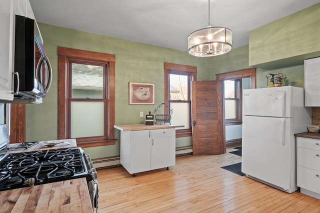 kitchen with stainless steel appliances, baseboard heating, light wood-style flooring, and white cabinetry