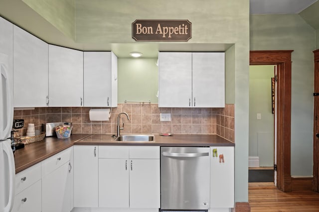 kitchen with a sink, backsplash, white cabinets, and stainless steel dishwasher