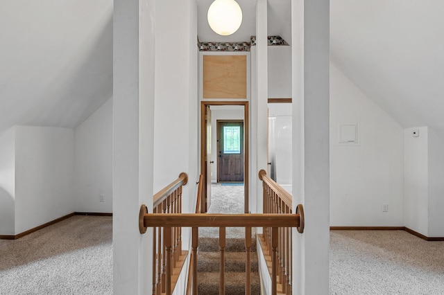 interior space featuring vaulted ceiling, baseboards, and carpet floors