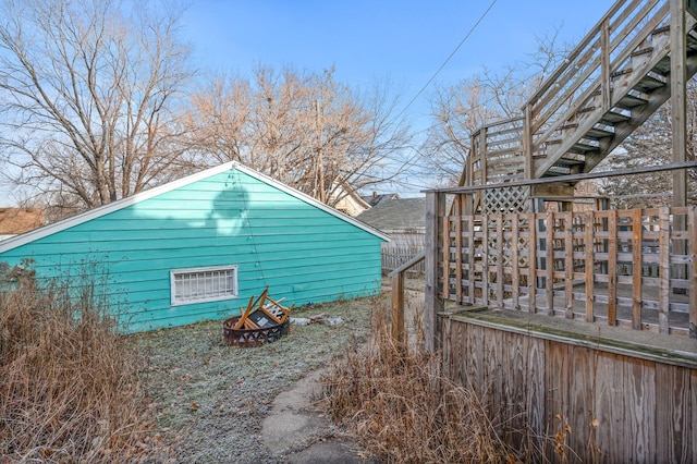 view of property exterior with a fire pit