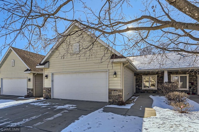 view of front of property with stone siding and driveway