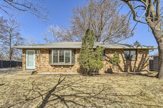 ranch-style home with brick siding and fence