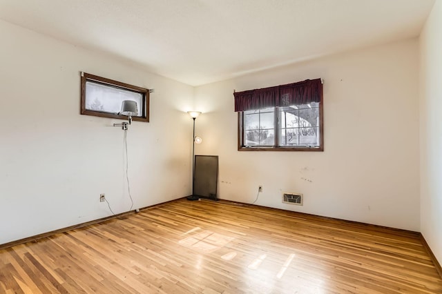 empty room with visible vents and light wood-style flooring