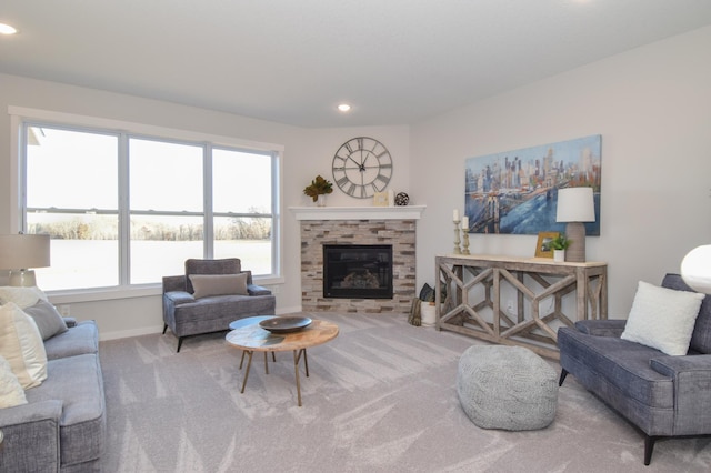 living area with a glass covered fireplace, carpet flooring, recessed lighting, and baseboards