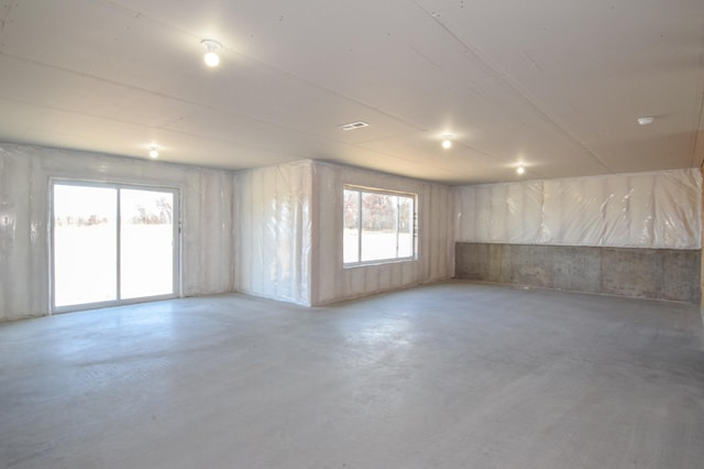 unfurnished room with concrete floors