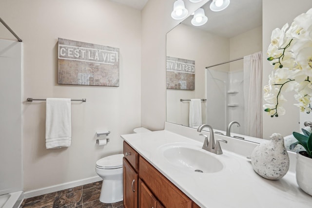 bathroom featuring toilet, baseboards, vanity, and a shower with curtain