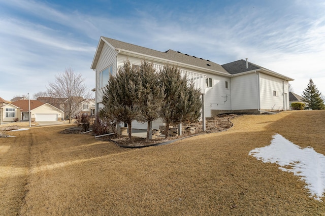 view of side of home with a lawn