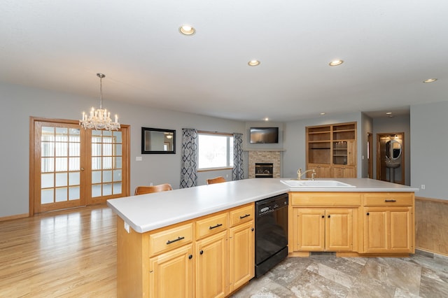 kitchen with a sink, open floor plan, recessed lighting, a brick fireplace, and dishwasher