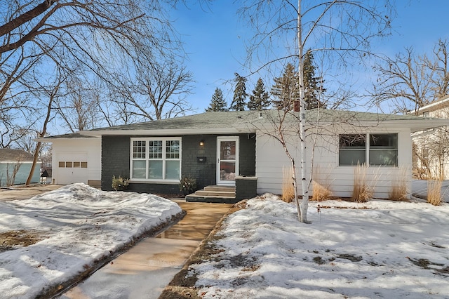 view of front of home featuring brick siding and an attached garage