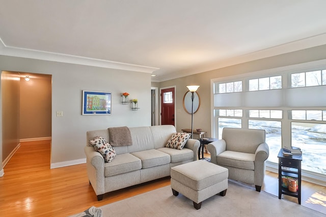 living room featuring baseboards and light wood finished floors