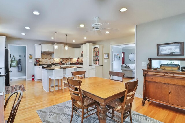 dining room featuring baseboards, recessed lighting, a ceiling fan, and light wood-style floors