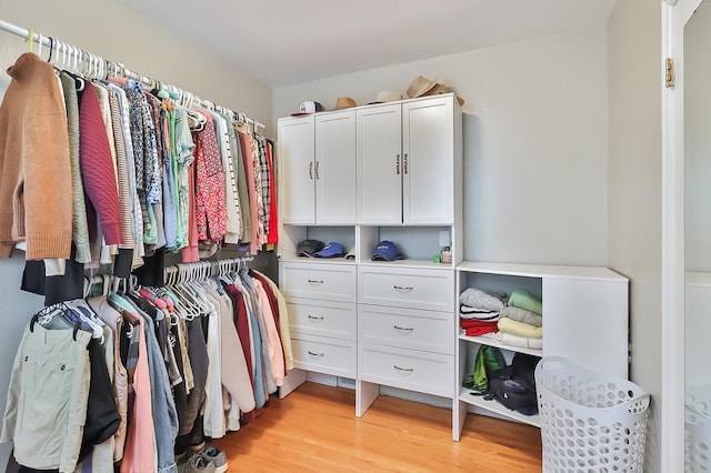 walk in closet featuring light wood finished floors