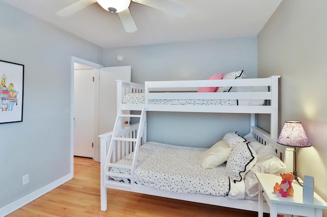 bedroom featuring a ceiling fan, baseboards, and wood finished floors