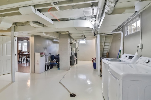 basement featuring washer and clothes dryer and heating unit