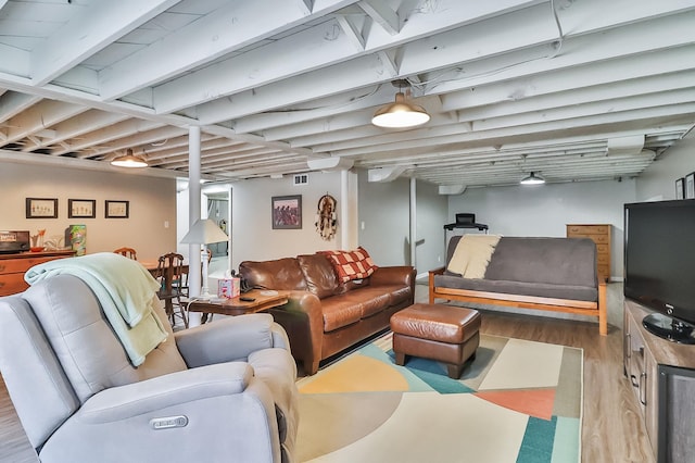 living area featuring wood finished floors and visible vents