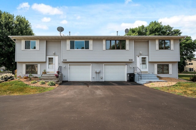 split foyer home featuring an attached garage and driveway