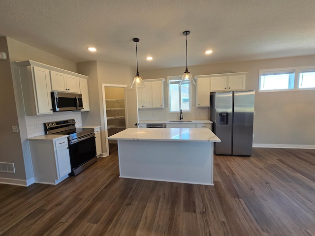 kitchen with visible vents, white cabinets, appliances with stainless steel finishes, and a sink