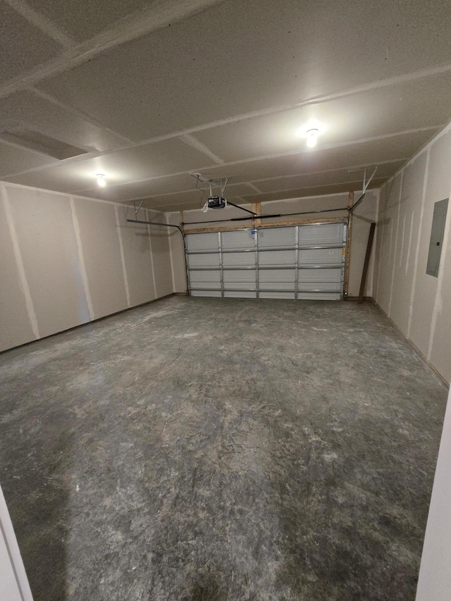 garage with electric panel and a garage door opener